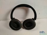 the black headphones are sitting on the white surface