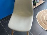 a white chair sitting in front of a blue wall