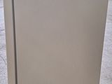 a white refrigerator sitting on a pallet in a warehouse