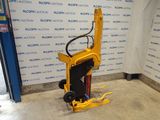 a close up of a fork lifter in front of a wall with a sign in the background