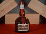 a bottle of grand marnier next to a box of wine