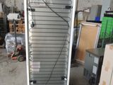 an image of a refrigerator in a warehouse with a lot of boxes in the background
