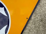 a close up of a street sign on the ground