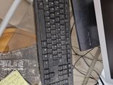 a keyboard and a mouse on a desk with a monitor
