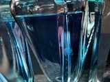 a glass vase with a blue liquid inside of it