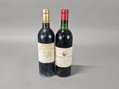 two bottles of wine sitting next to each other on a table