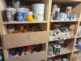 many cans of paint on the shelves in the room