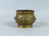 an image of a brass vase with a flower design on it