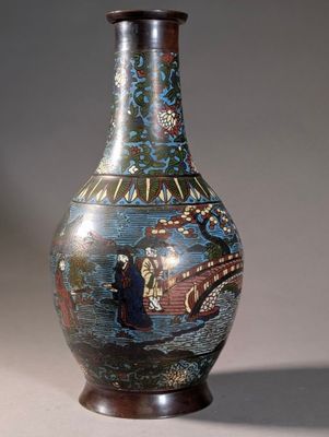 a vase with a painting on it sitting on a table