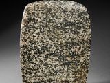 a stone block with black and white speckles on it