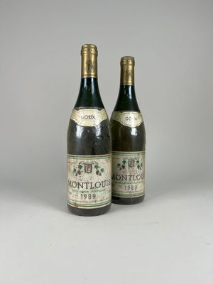 two bottles of wine sitting next to each other on a table