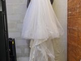 a wedding dress hanging on a wall in a room