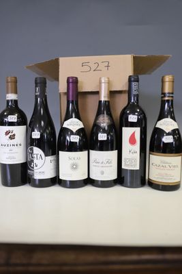several bottles of wine are lined up in a row on a table
