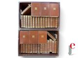 two wooden boxes with books in them on a white surface