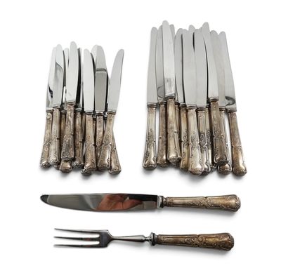 a set of knives and a fork on a white surface