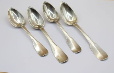 six silver spoons sitting on top of a white surface
