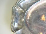 a silver plate with a picture of a woman ' s face on it