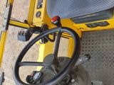 a close up view of the steering wheel of a construction vehicle