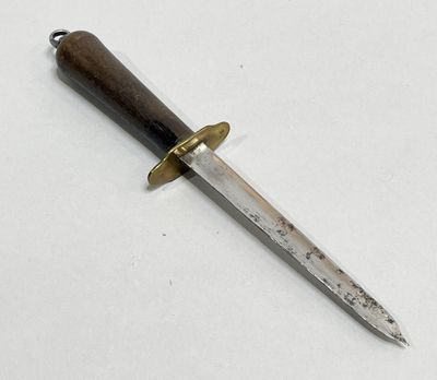 a knife that is laying on a white surface