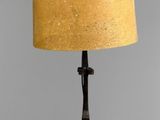 a table lamp with a cork shade on top of it