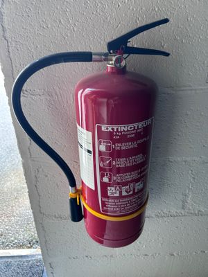 a fire extinguisor attached to a wall
