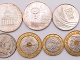 six different types of coins are shown on a white surface