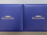 a pair of blue boxes with the logo of monaco de paris on them
