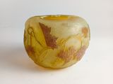 a yellow and brown bowl sitting on a white surface