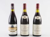 three bottles of wine sit side by side on a white surface