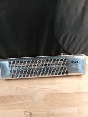un radiateur électrique argenté et noir posé sur une table en bois