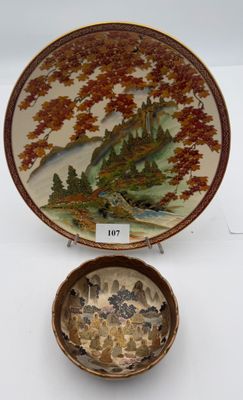 two plates with a painting on them sitting next to each other