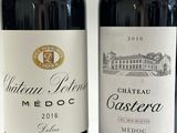 two bottles of wine sitting next to each other on a table