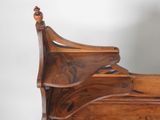a wooden bed with a wooden headboard and foot board