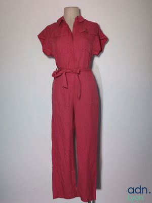 red jumpsuit with belted waist and short sleeves on a mannequin mannequin mannequin mannequin mannequin mannequin manne