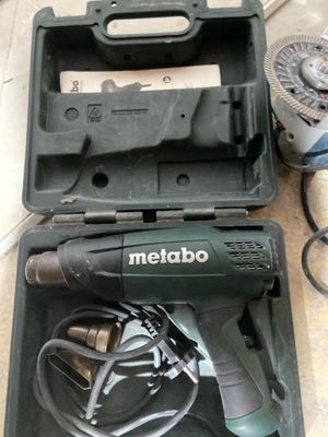 a corded drill in a case on the floor