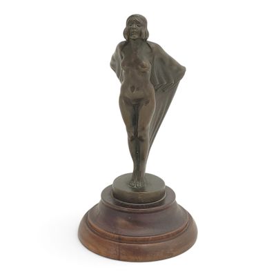 statue of a woman holding a umbrella on a wooden base