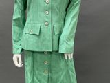 an image of a mannequin dressed in a green suit and skirt