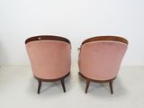 pair of pink velvet chairs with wooden legs