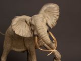 a statue of an elephant that is standing on a table