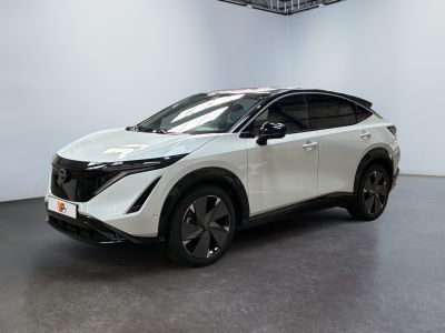 the white nissan suv is parked in a room with a black floor