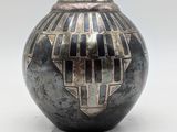 a black and white vase with a geometric design on it