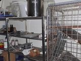 a large metal cage filled with various items in a room