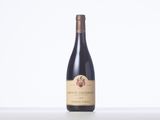 a bottle of red wine sitting on top of a table