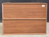 a wooden box with two drawers on top of it