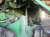 a large green machine that is parked in a building