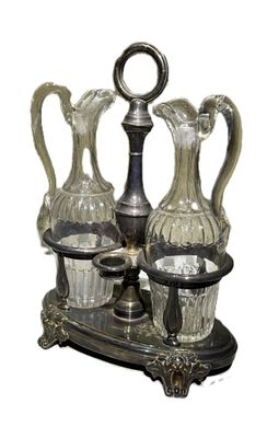 trois vases en verre et un plat en argent posé sur un socle
