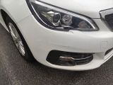 a close up of a white car parked in a parking lot