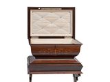 a wooden casket sitting on top of a wooden table