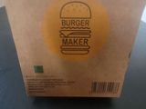 a cardboard box with a burger on it on a table