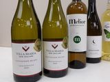 several bottles of wine are lined up on a table